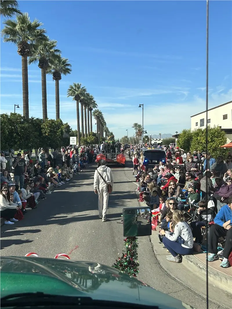 Phoenix staff posing together at the Christmas in the Park parade
