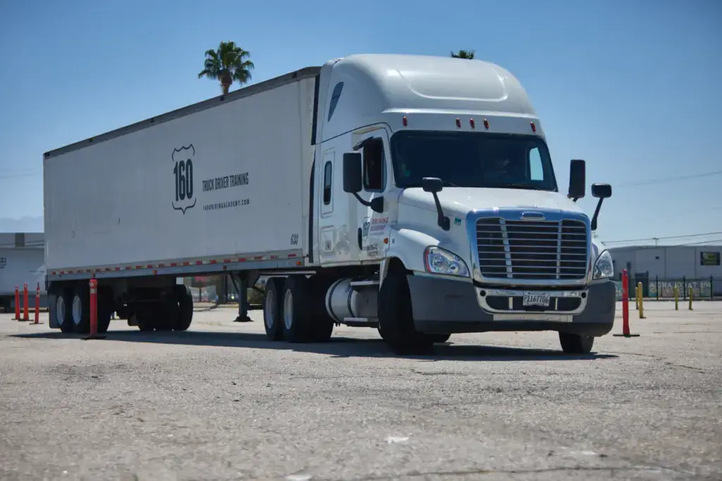 White tractor trailer in parking lot
