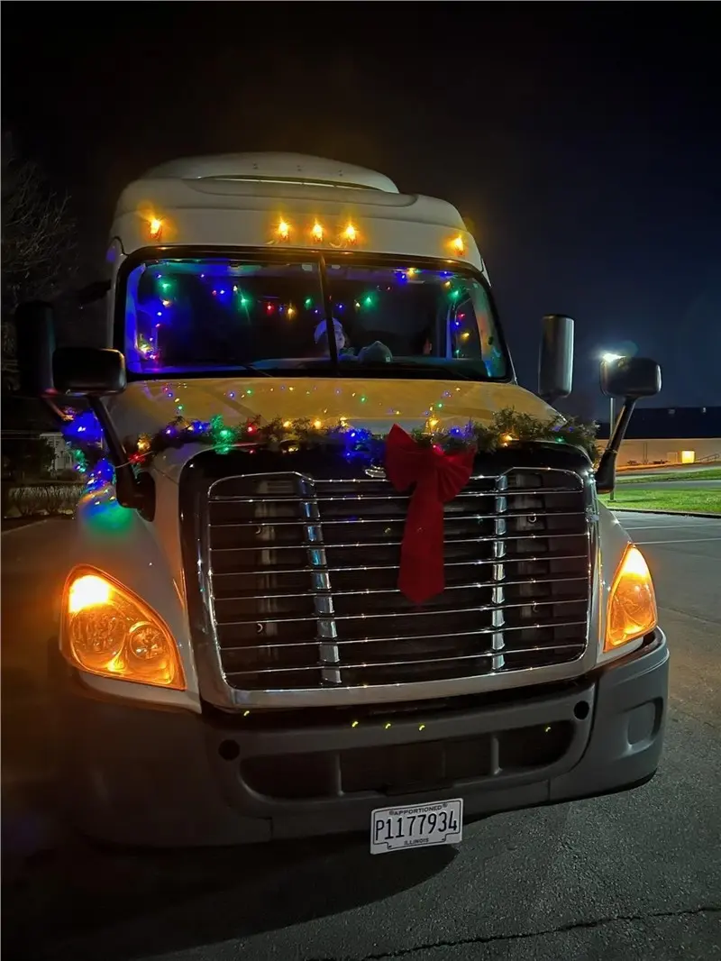 Truck decorated with holiday lights and red bow