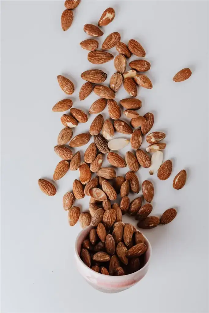 almonds in bowl scattered nuts