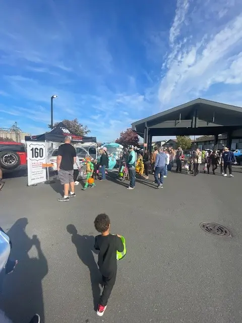 Crowd attending Trunk or Treat event outdoors