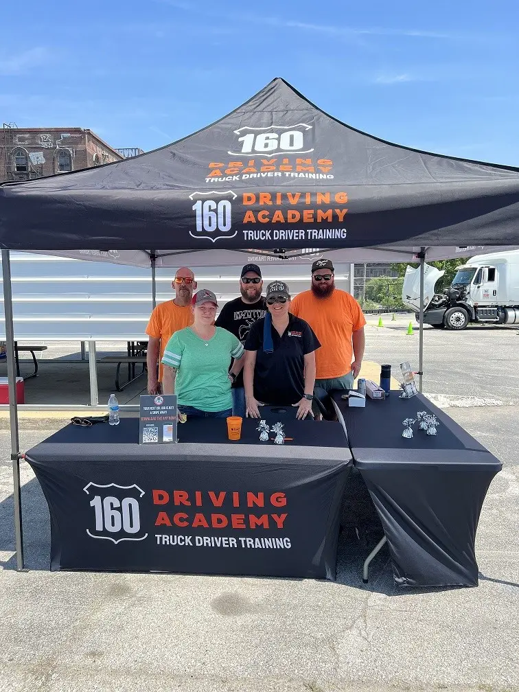 Group of people at 160 Driving Academy booth