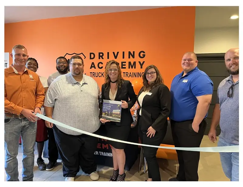 Group ribbon-cutting at Driving Academy event