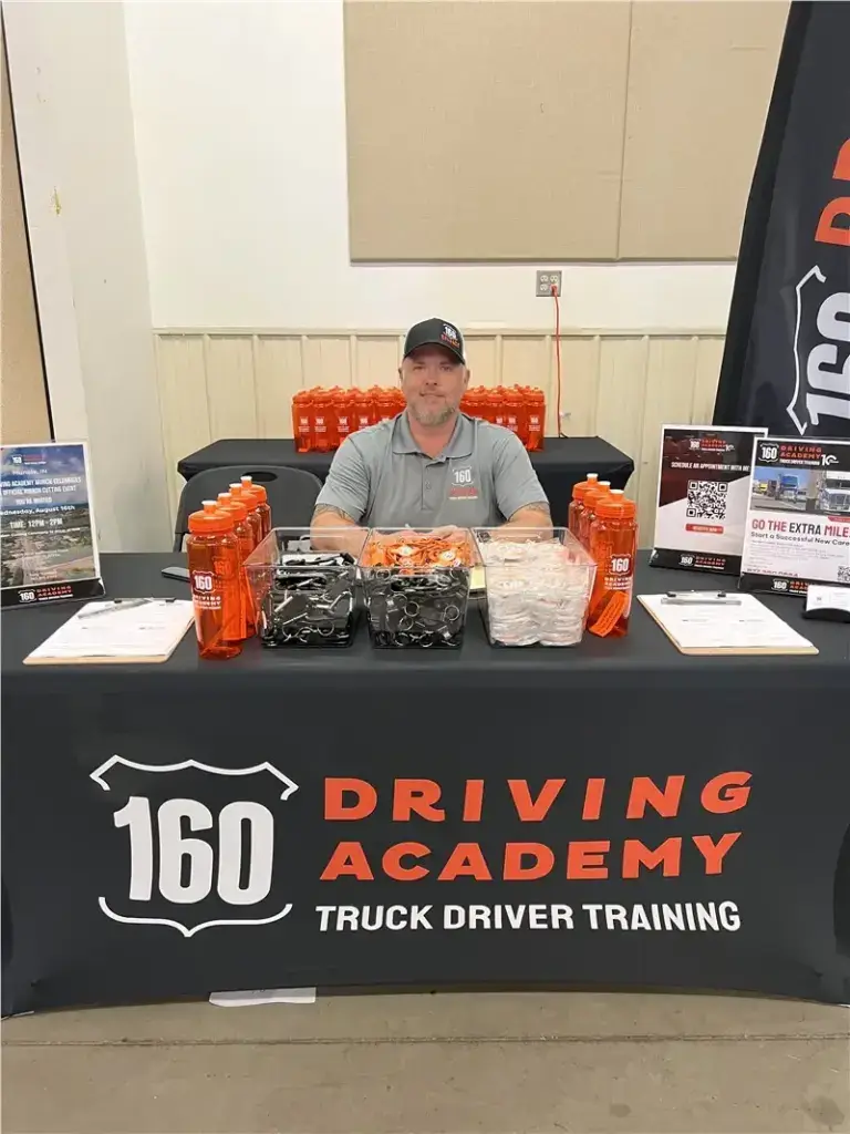 160 Driving Academy booth display with promotional items