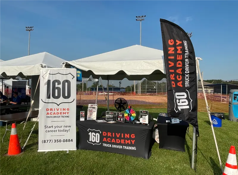 160 Driving Academy booth at an outdoor event