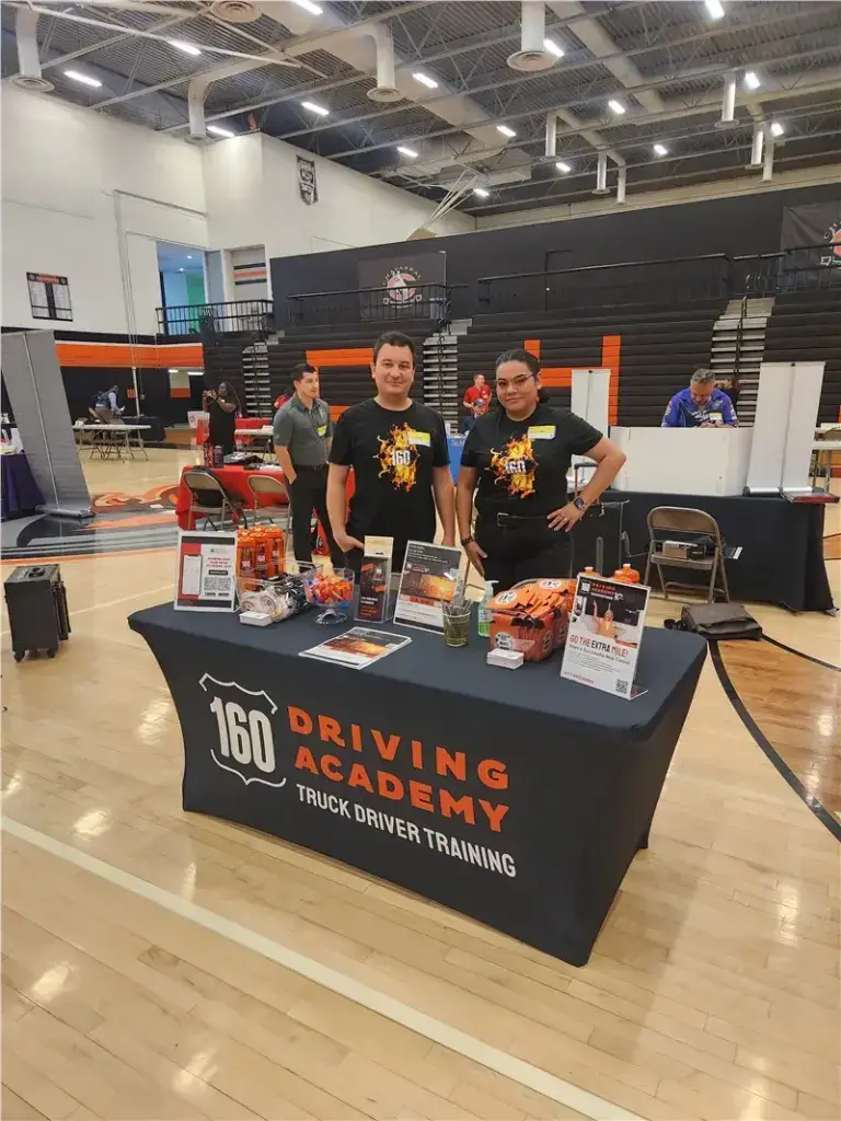 160 Driving Academy event booth with representatives