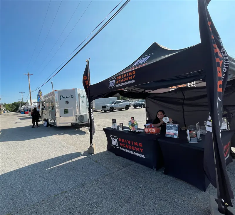 160 Driving Academy booth with informational materials displayed