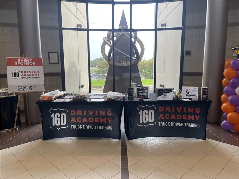160 Driving Academy event display with promotional materials