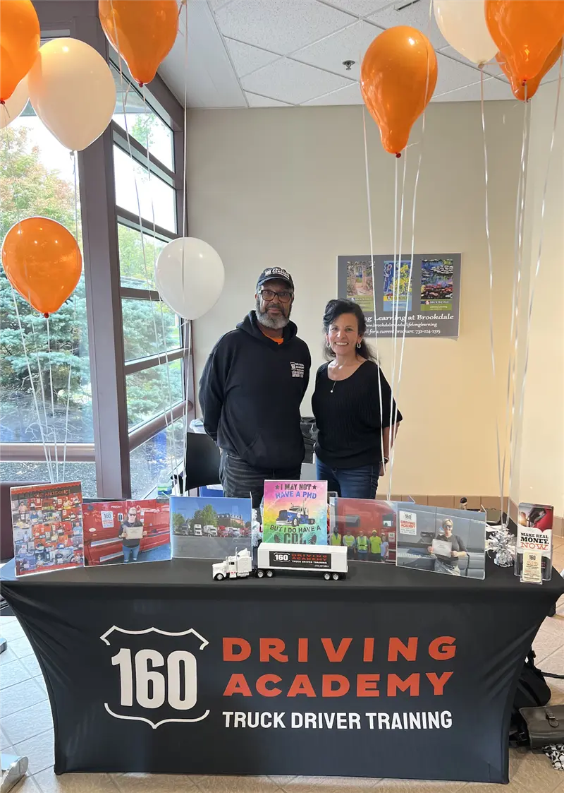 160 Driving Academy event display with two people