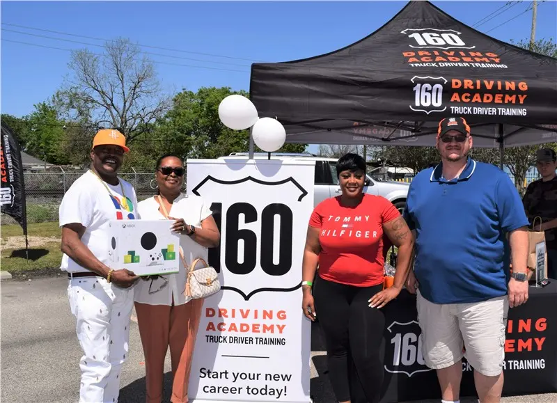 People smiling at a driving academy event