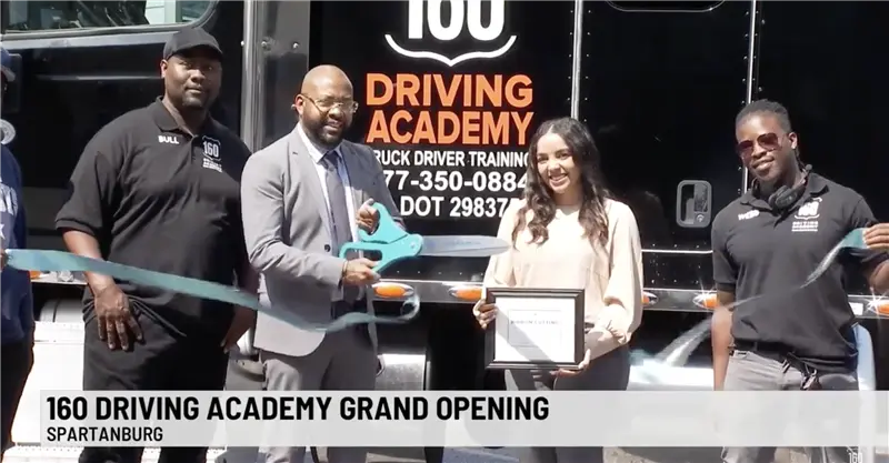 Group celebrating 160 Driving Academy grand opening event