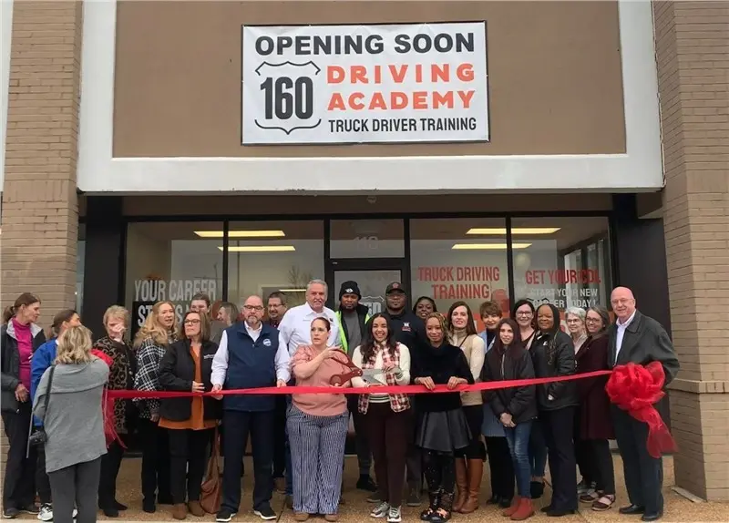 Group of people at driving academy grand opening