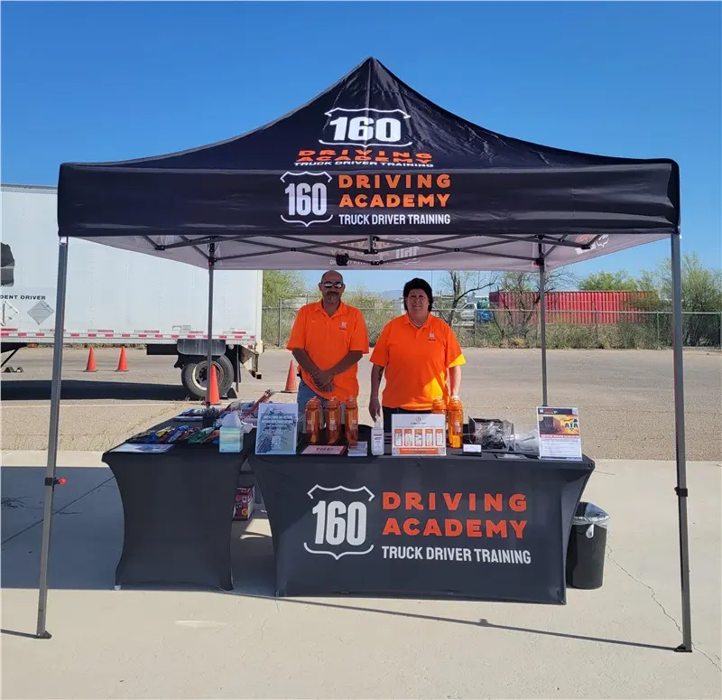 Two staff members at 160 Driving Academy stand