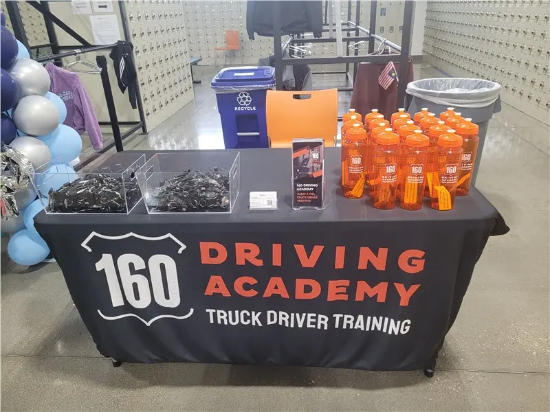 Promotional table with bottles and keychains displayed