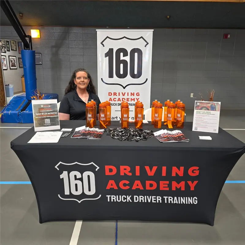 160 Driving Academy promotional booth with staff member