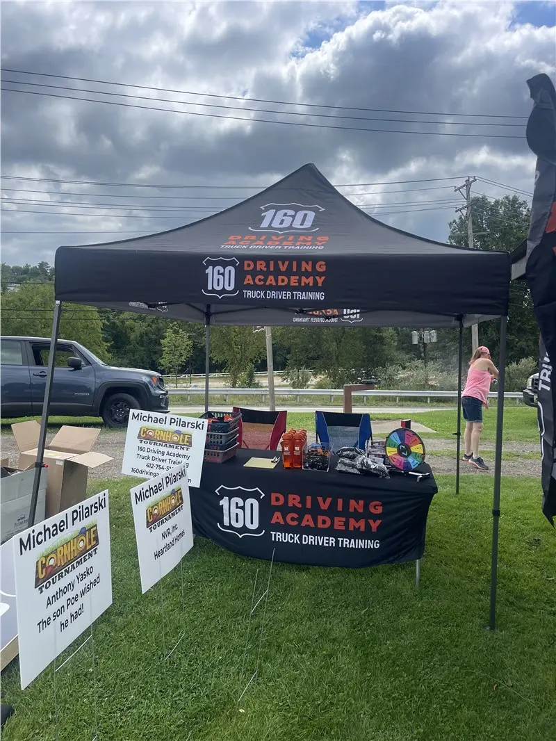 160 Driving Academy promotional booth at outdoor event