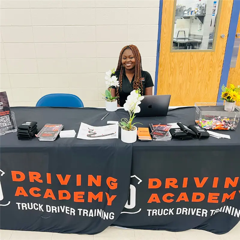 Recruiter at a Driving Academy information table