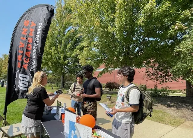 Recruiter speaking with students at outdoor event