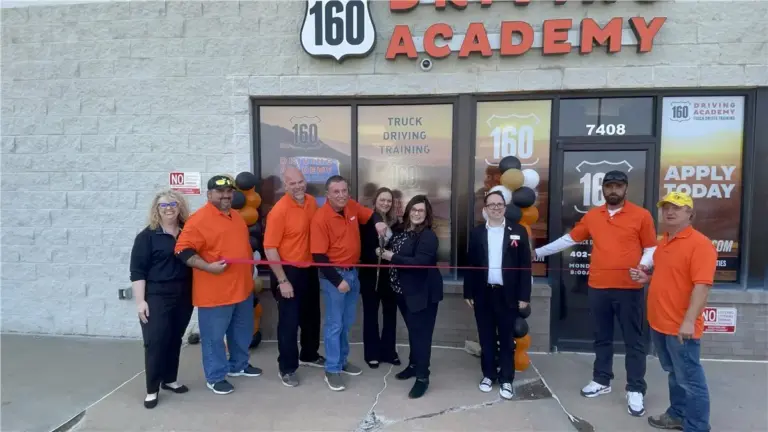 People cutting ribbon at 160 Driving Academy opening
