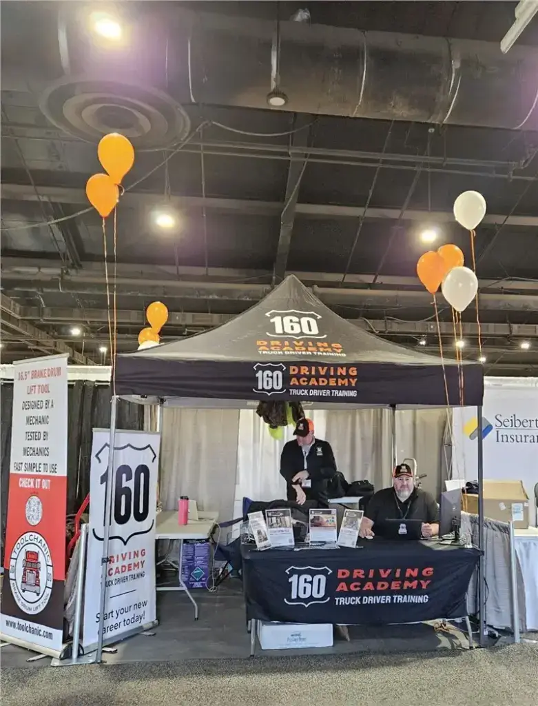 160 Driving Academy trade show booth with balloons