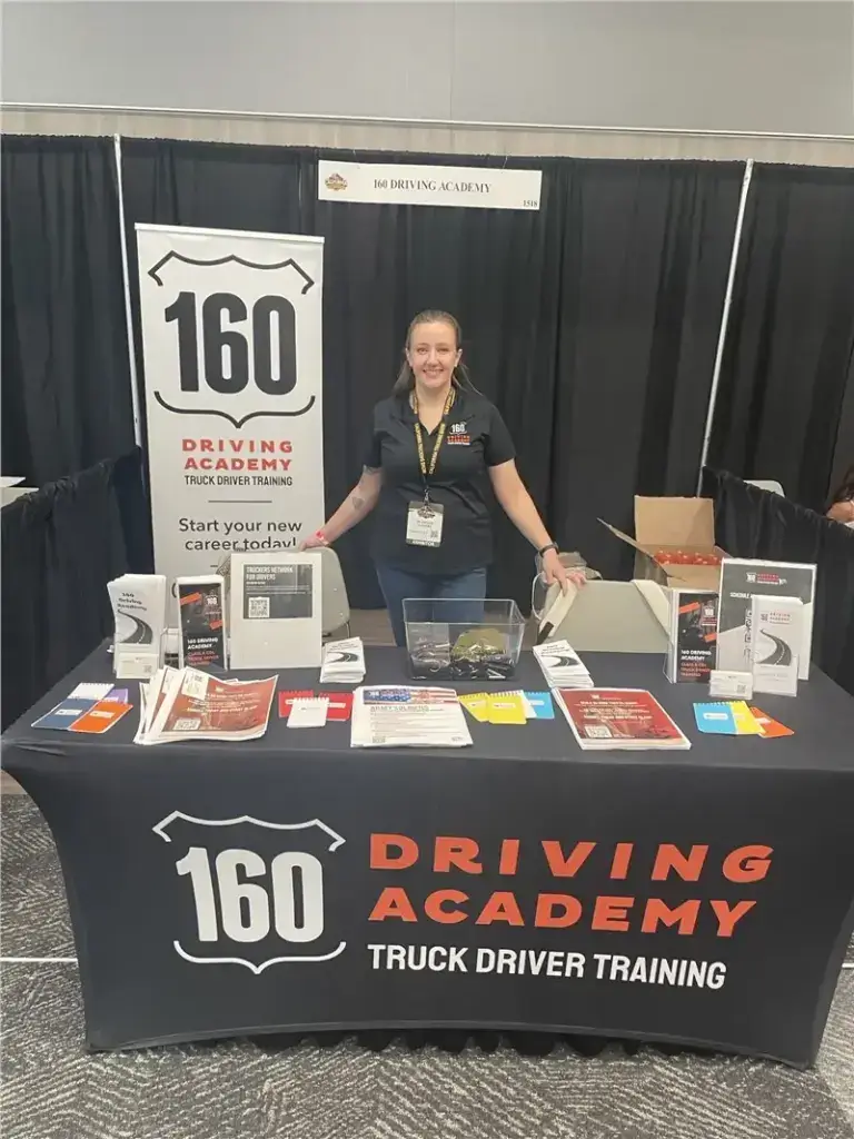 160 Driving Academy trade show booth with representative
