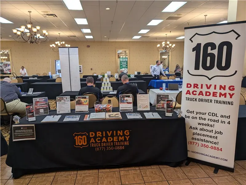 160 Driving Academy booth with informational display