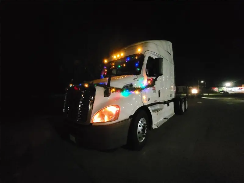 Truck decorated with lights at night parade