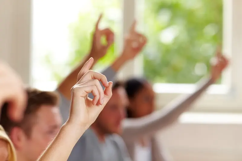 raised hands classroom setting