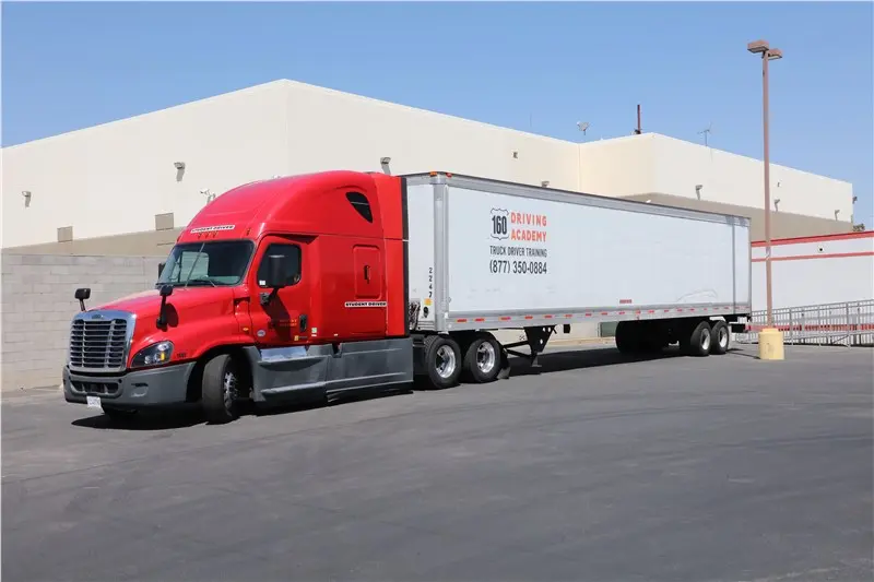 red semi truck parked outdoors