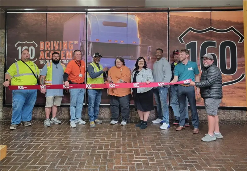Group at ribbon-cutting ceremony at 160 Driving Academy