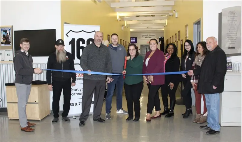 Group cutting ribbon at 160 Driving Academy event