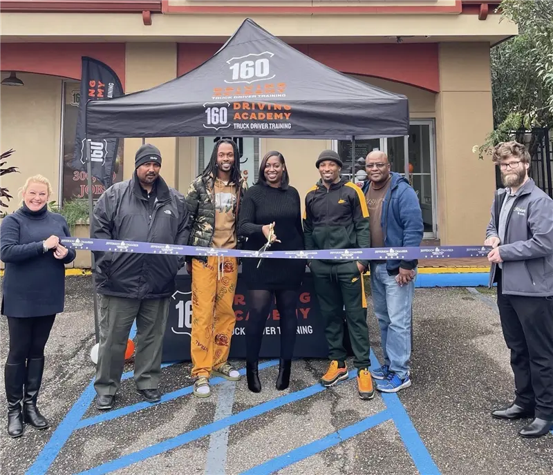 Group ribbon-cutting ceremony at 160 Driving Academy