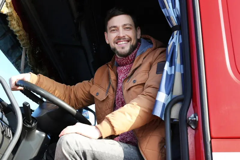 Smiling man driving a truck