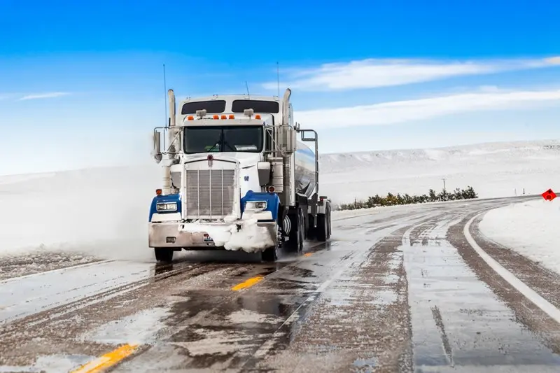 snowy road with truck
