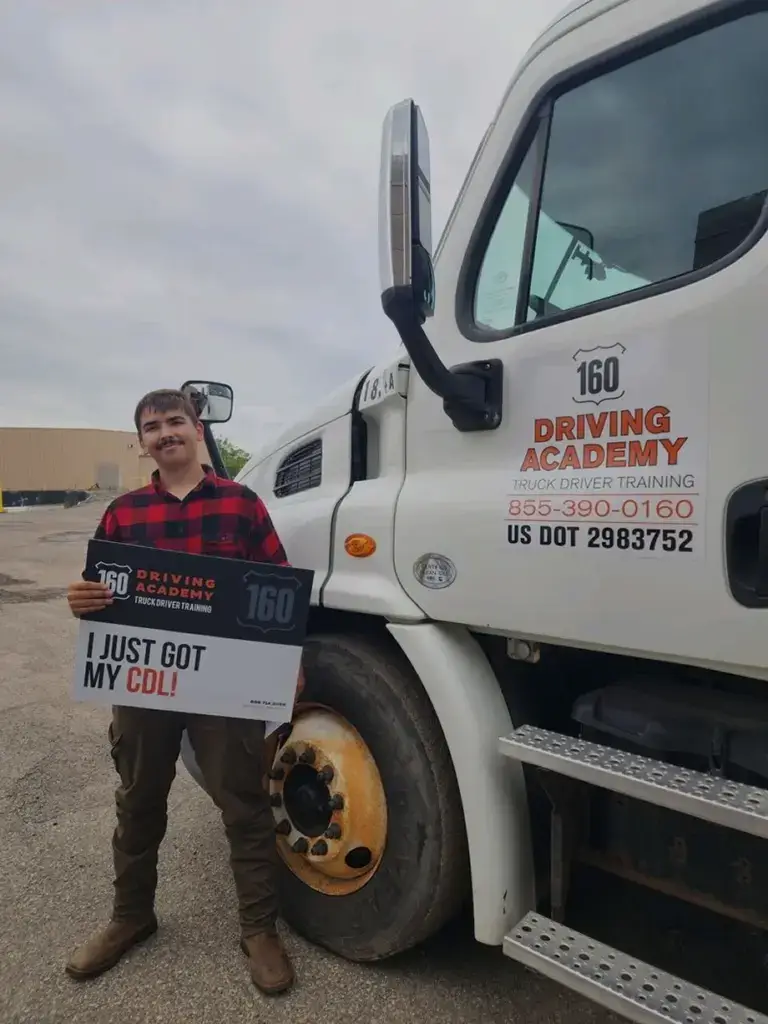 truck driver graduate holding sign
