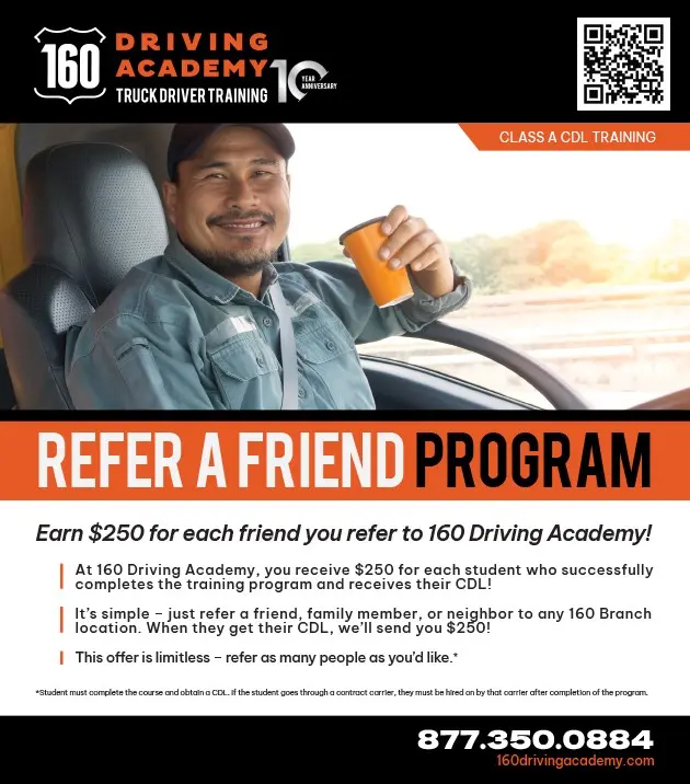 Smiling man holding coffee in truck cab