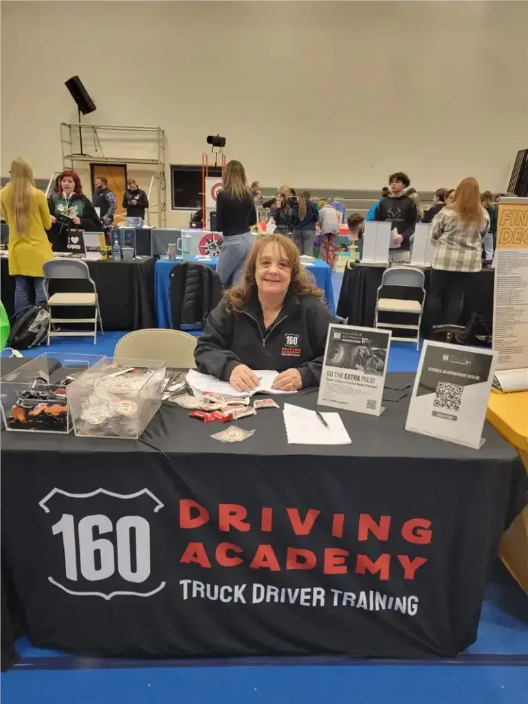 Woman at 160 Driving Academy information booth