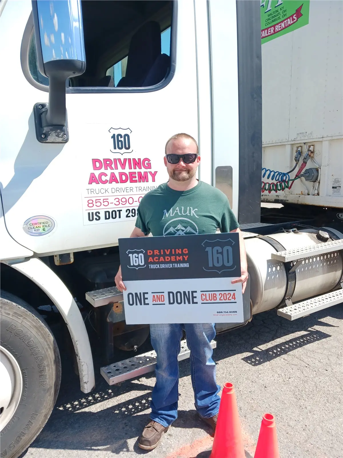 Man holding sign by 160 Driving Academy truck