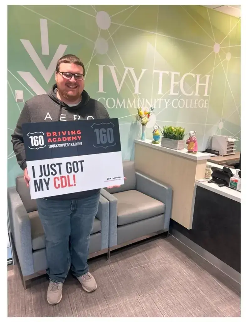 Graduate holding CDL sign at Ivy Tech College