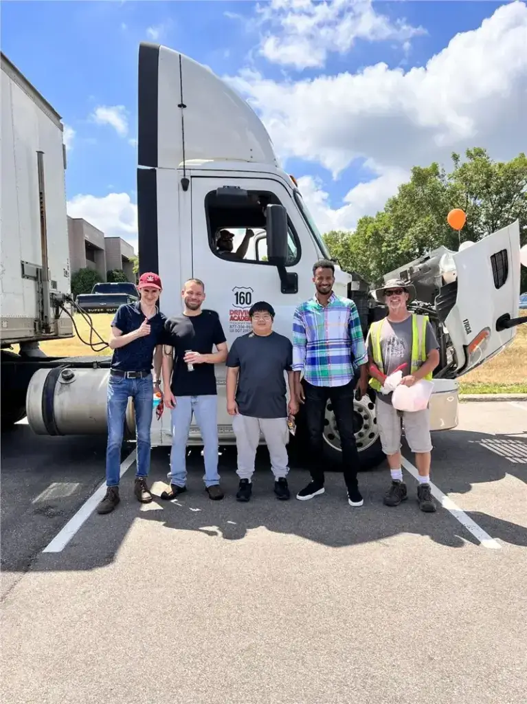 Group of truck drivers standing by a truck
