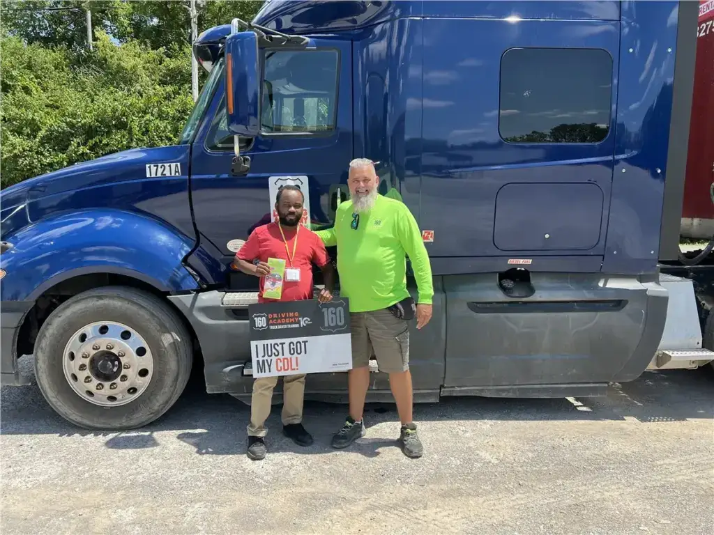 Two men celebrating truck driving graduation