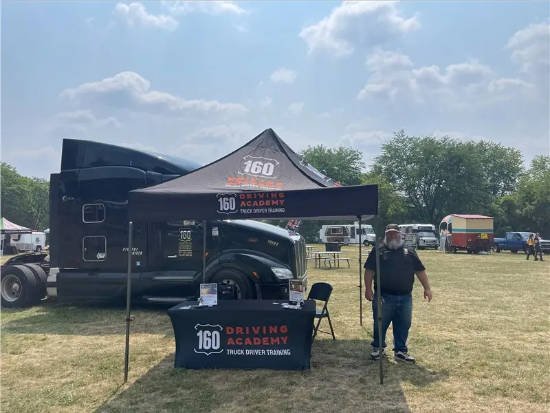 160 Driving Academy booth with truck display