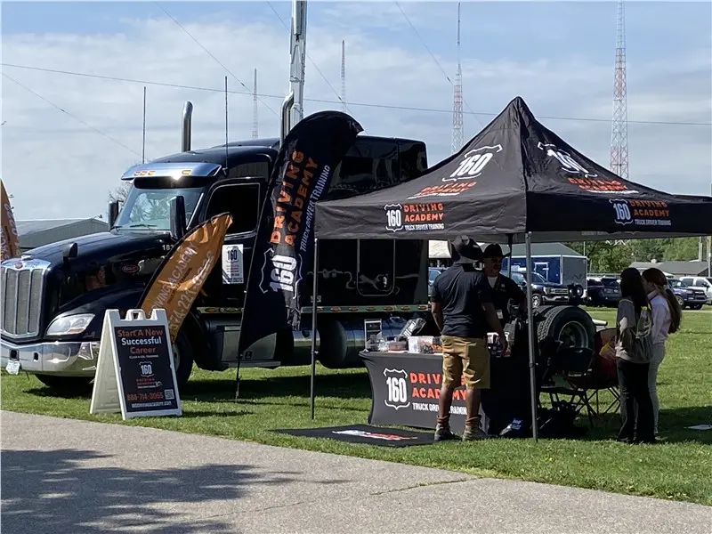 Booth promoting 160 Driving Academy truck training