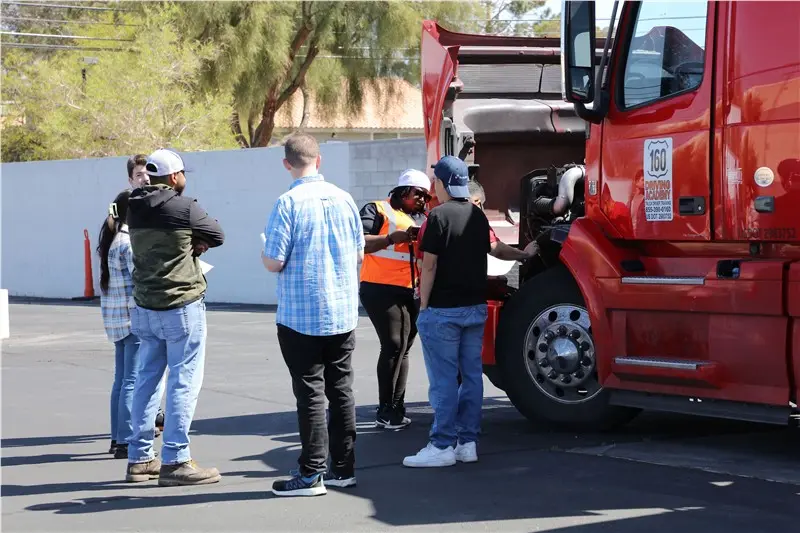 Training session on truck maintenance outdoors