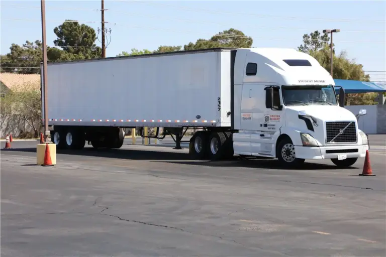 White semi-truck parked between traffic cones