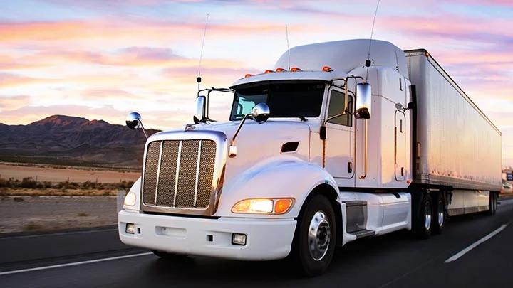 white semi truck sunset road
