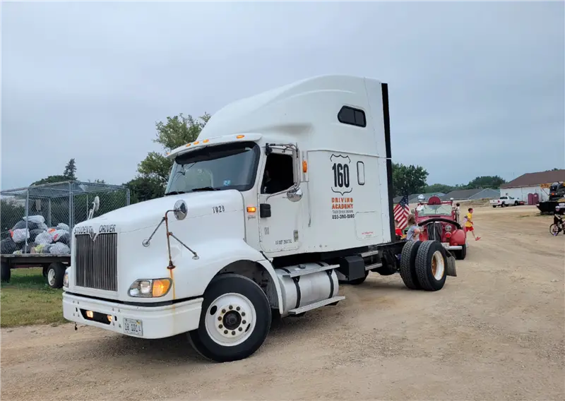 White semi truck parked on a dirt road